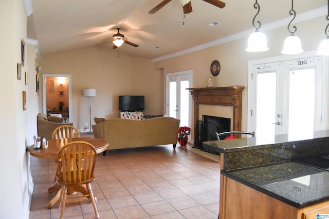 tiled living room featuring lofted ceiling, ornamental molding, french doors, and ceiling fan