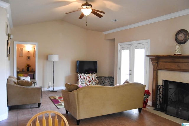 tiled living room with french doors, ceiling fan, lofted ceiling, and ornamental molding