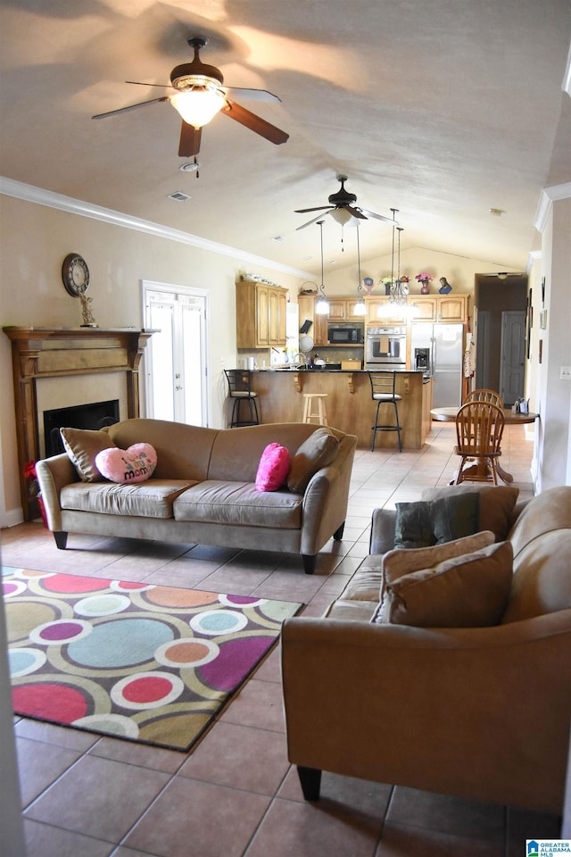 tiled living room with ceiling fan, ornamental molding, and lofted ceiling