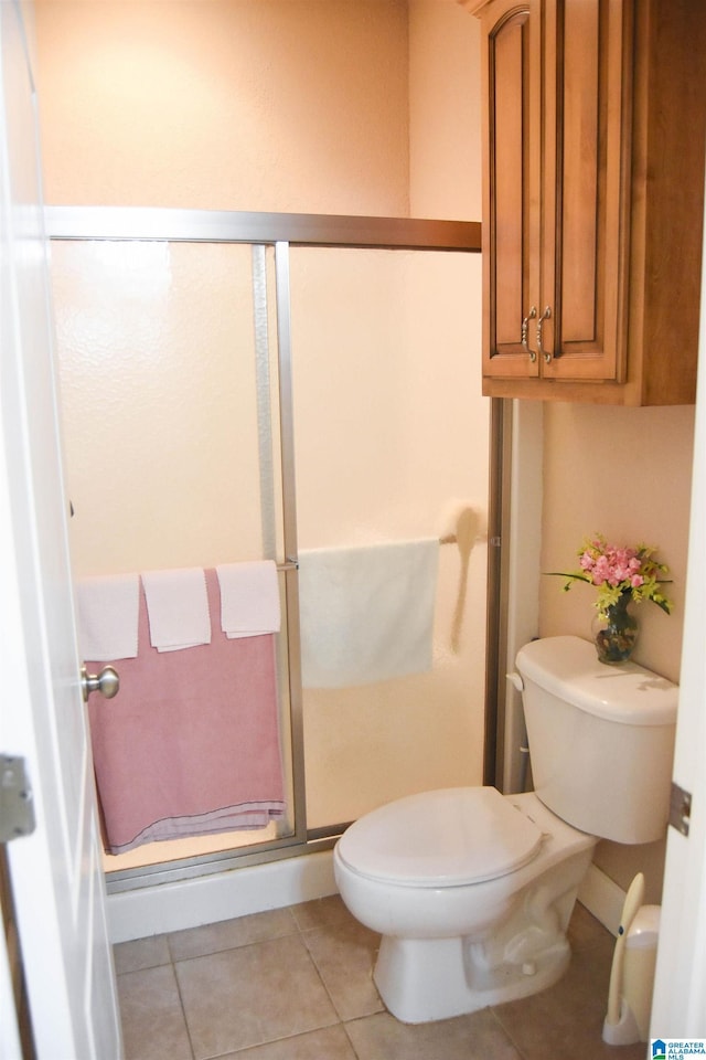 bathroom featuring tile patterned flooring and toilet