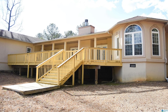 back of property featuring a deck