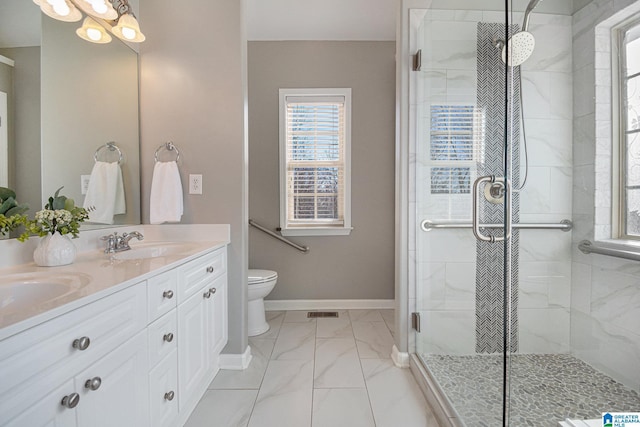 bathroom featuring an enclosed shower, vanity, and toilet