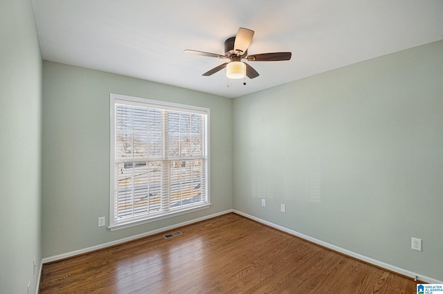 empty room with hardwood / wood-style flooring and ceiling fan