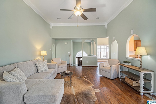 living room featuring dark hardwood / wood-style flooring, ornamental molding, and ceiling fan