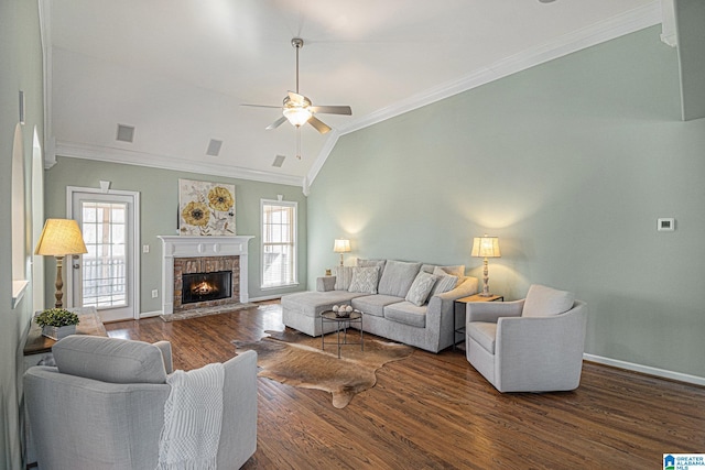 living room featuring dark wood-type flooring, a healthy amount of sunlight, ornamental molding, and lofted ceiling