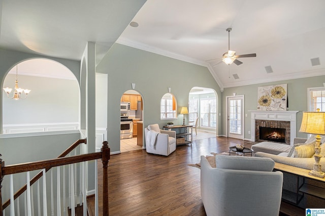 living room featuring crown molding, a healthy amount of sunlight, and dark hardwood / wood-style flooring