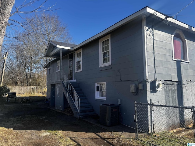 view of side of home with central air condition unit