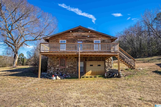 exterior space featuring a wooden deck and a lawn