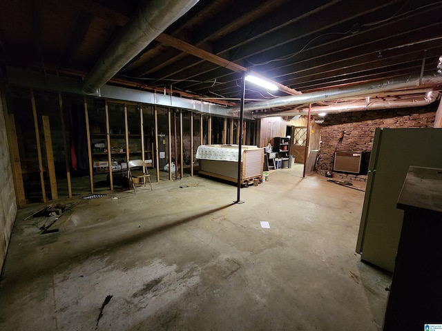 basement with stainless steel refrigerator