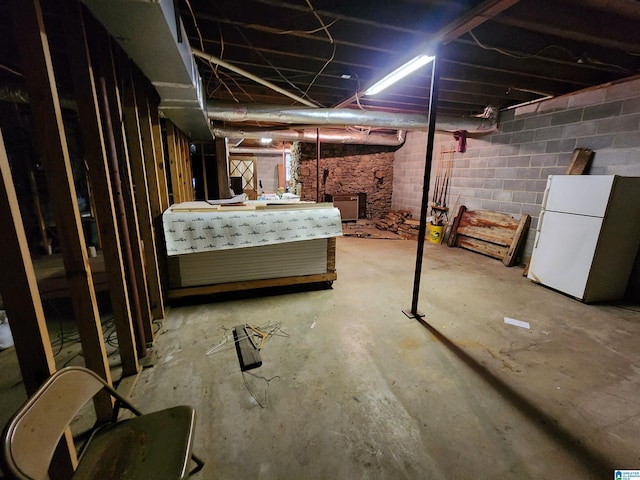 basement with white refrigerator