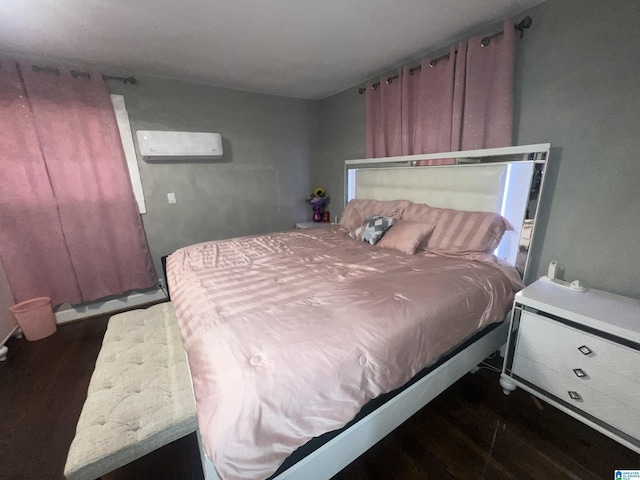 bedroom featuring dark hardwood / wood-style flooring and a wall mounted AC