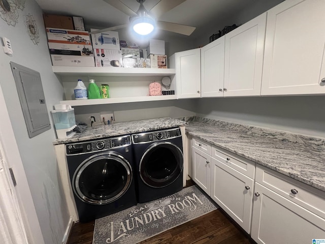 laundry area featuring dark wood-type flooring, ceiling fan, electric panel, cabinets, and washer and dryer