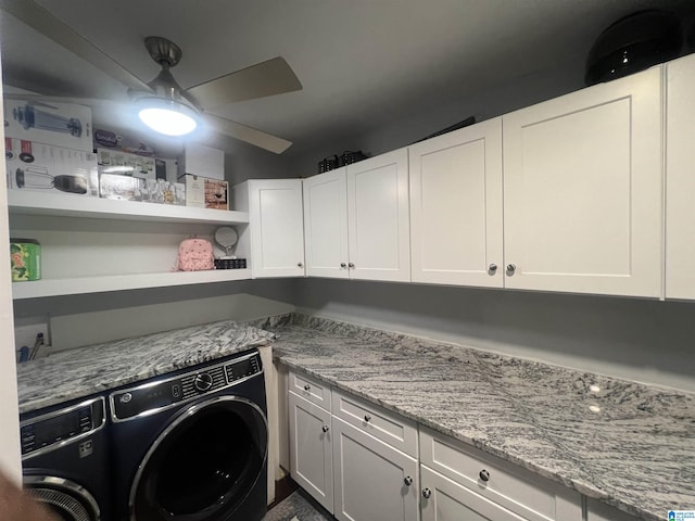 clothes washing area with ceiling fan, cabinets, and washing machine and clothes dryer