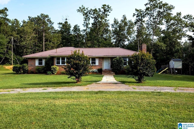 single story home featuring a playground and a front yard