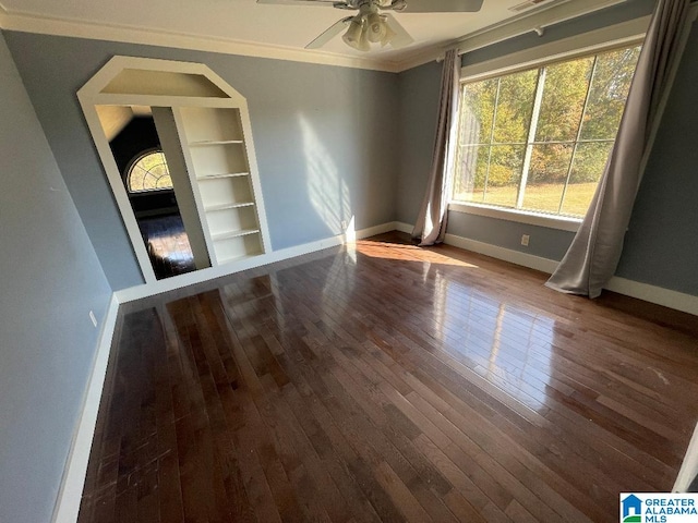 spare room with crown molding, wood-type flooring, and ceiling fan