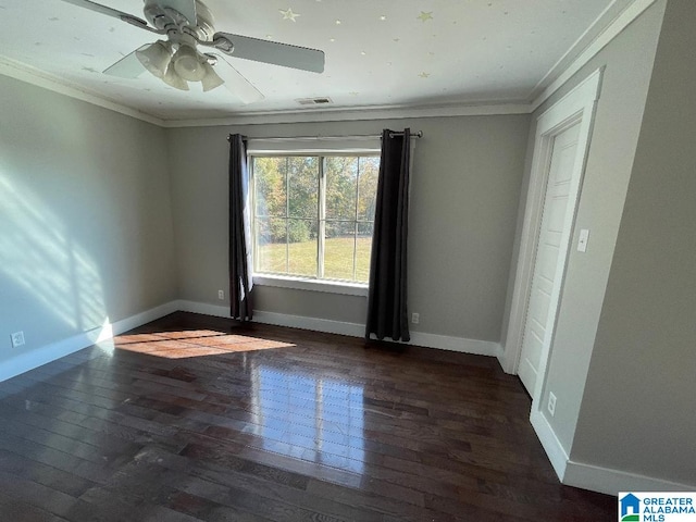 empty room featuring crown molding, dark hardwood / wood-style floors, and ceiling fan