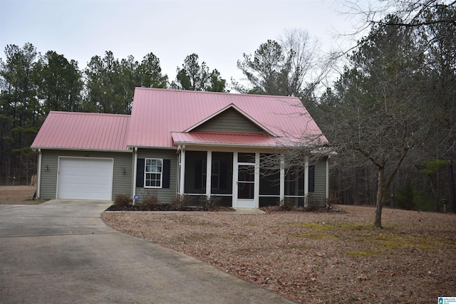 view of front of home featuring a garage and a sunroom