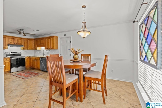 dining area with ornamental molding, sink, light tile patterned floors, and ceiling fan