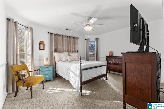 bedroom featuring ceiling fan and light carpet