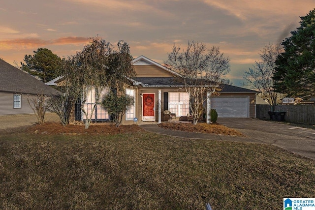 view of front of home featuring a garage and a lawn