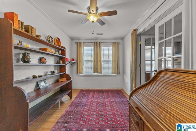 sitting room featuring crown molding, hardwood / wood-style flooring, and ceiling fan