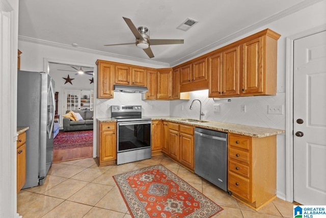 kitchen with stainless steel appliances, ornamental molding, sink, and backsplash