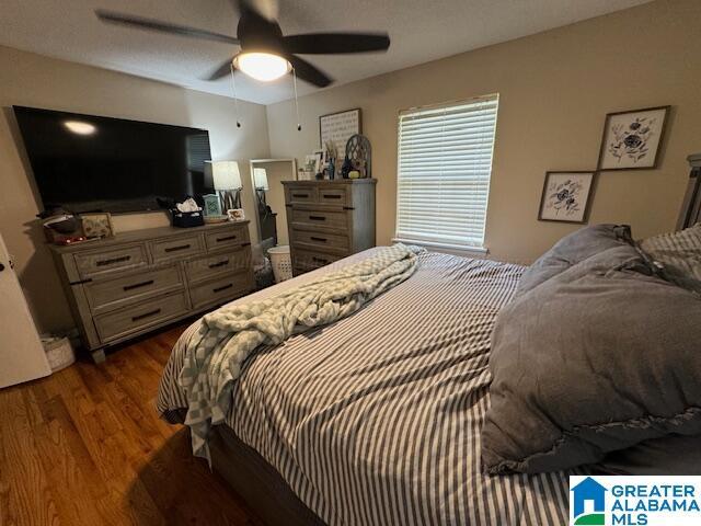 bedroom featuring dark hardwood / wood-style flooring and ceiling fan