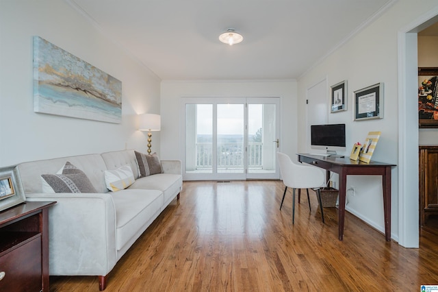 office area with ornamental molding and hardwood / wood-style floors