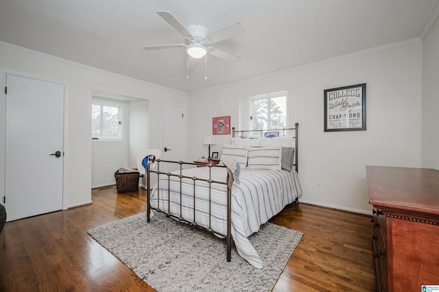 bedroom with ceiling fan, ornamental molding, and dark hardwood / wood-style flooring