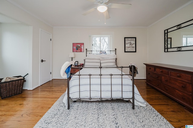 bedroom featuring ceiling fan, ornamental molding, and hardwood / wood-style floors