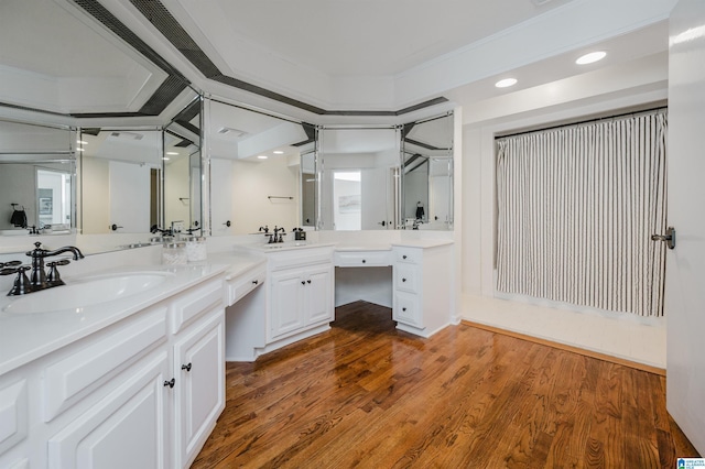 bathroom with vanity, hardwood / wood-style floors, and crown molding