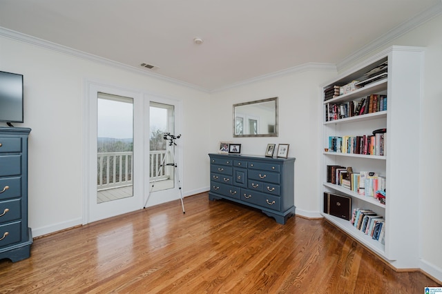 living area featuring light hardwood / wood-style flooring and ornamental molding