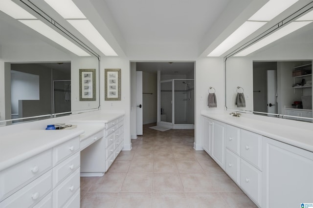 bathroom featuring tile patterned flooring, vanity, and an enclosed shower