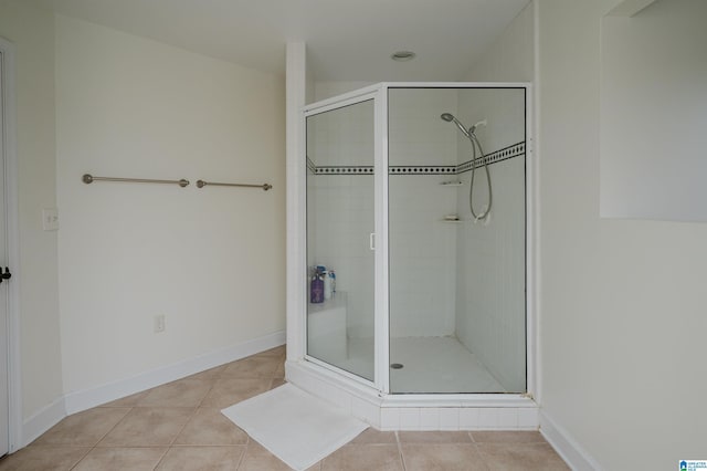 bathroom featuring walk in shower and tile patterned flooring