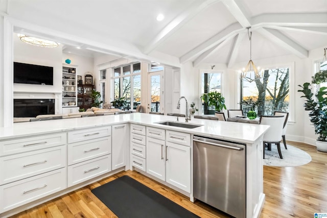 kitchen with white cabinetry, dishwasher, sink, kitchen peninsula, and an inviting chandelier