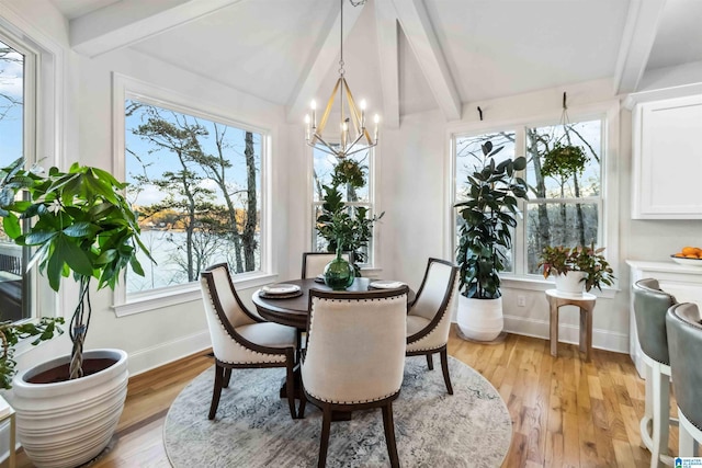 sunroom / solarium with a notable chandelier and a healthy amount of sunlight