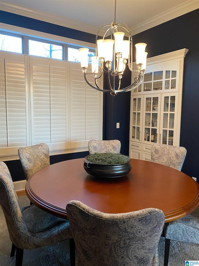 dining area with ornamental molding and a notable chandelier