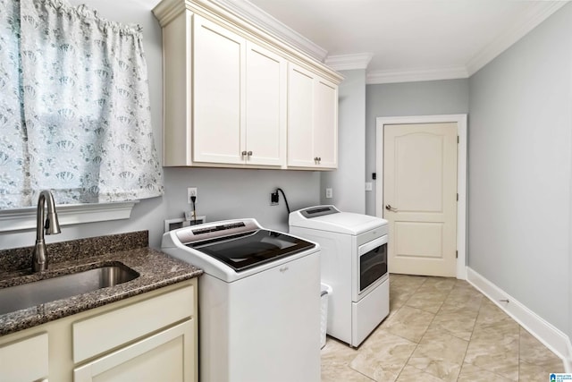 washroom featuring crown molding, cabinets, separate washer and dryer, and sink