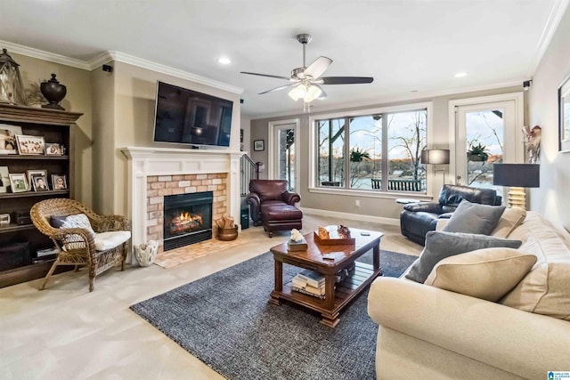 living room with crown molding, ceiling fan, and a brick fireplace