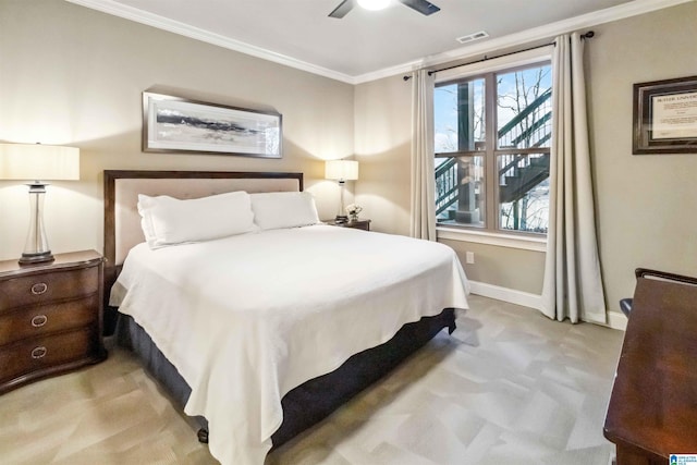 carpeted bedroom with ornamental molding and ceiling fan