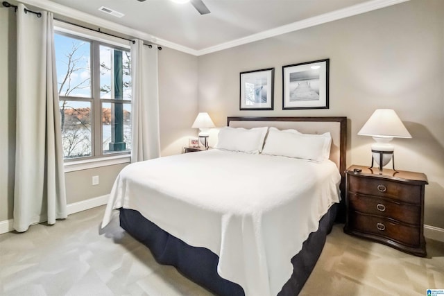 carpeted bedroom with crown molding and ceiling fan