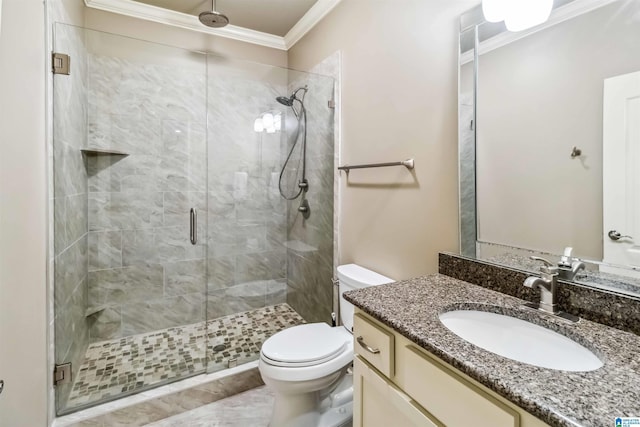 bathroom featuring a shower with door, crown molding, vanity, and toilet