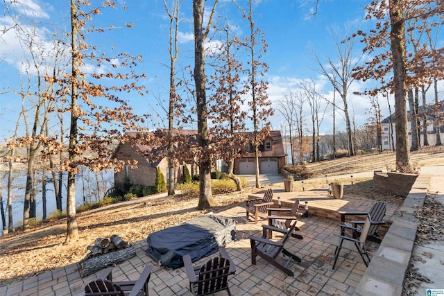 view of patio / terrace featuring a garage and a fire pit