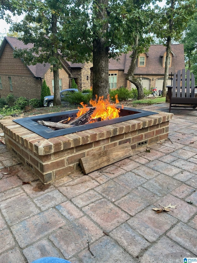 view of home's community with a patio area and an outdoor fire pit