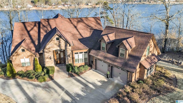 view of front of house with a garage and a water view