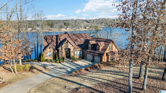 view of front of property with a garage and a water view