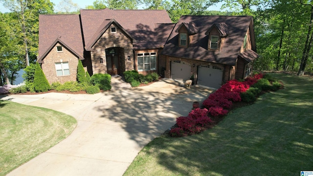 705 Lakeview Crest Dr, Pell City, AL 35128 - view of front of house with concrete driveway, a front yard, stone siding, and brick siding
