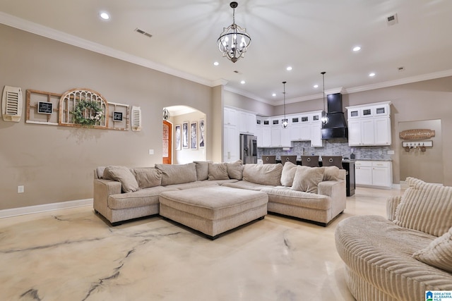 living room featuring crown molding and a chandelier