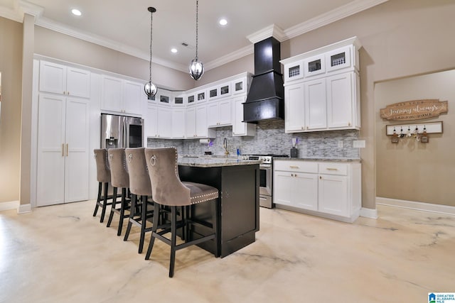 kitchen with custom range hood, an island with sink, white cabinets, and appliances with stainless steel finishes