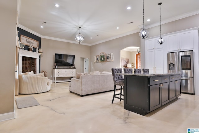 living room featuring a notable chandelier and crown molding